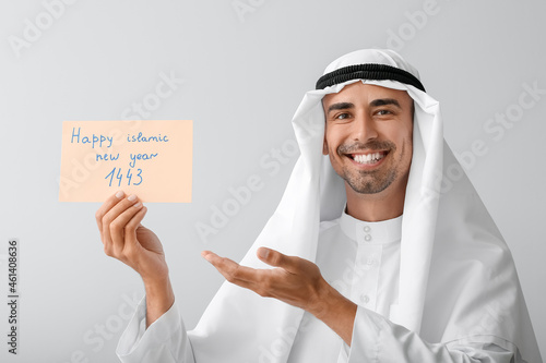 Young Muslim man with greet...
