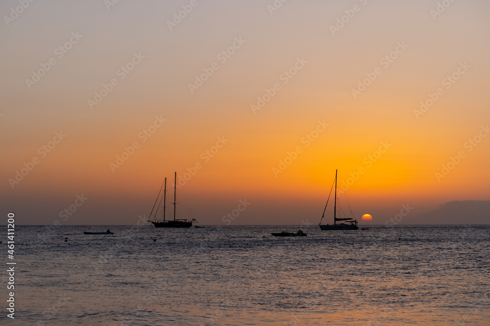sunset by the beach with boats