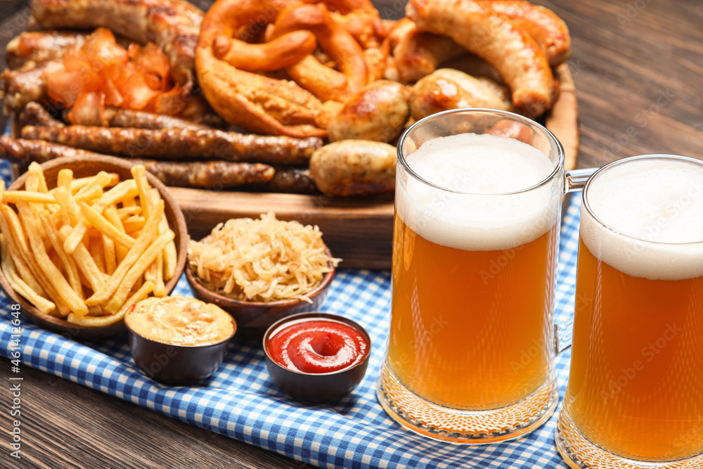 Mugs of cold beer and snacks on table. Oktoberfest celebration