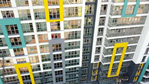 Smooth camera flight upward with a view of a beautiful new residential building and a business center. Modern architecture. 25 September 2021, Minsk, Belarus