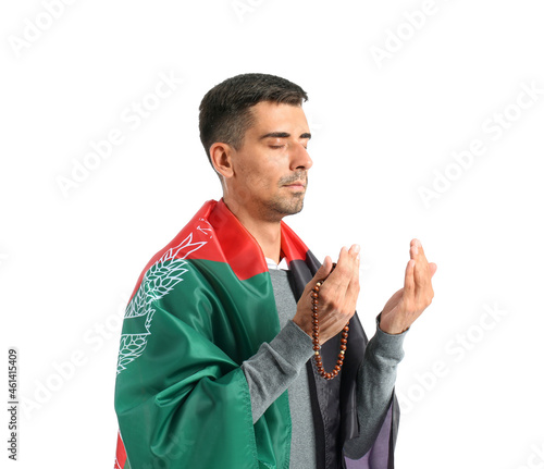 Praying Muslim man with fla...