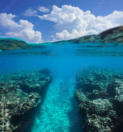 Natural trench in the reef underwater ocean and blue sky with cloud, seascape over and under water surface, south Pacific, French Polynesia