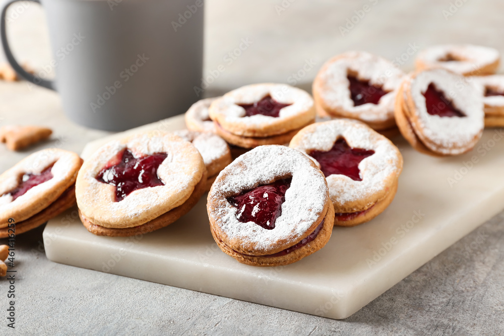 Board with tasty Linzer cookies on grunge background Board with tasty Linzer cookies on grunge background