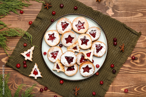 Plate with tasty Linzer cookies on table