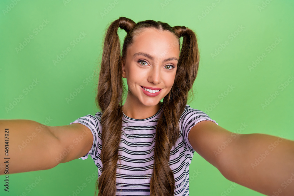 Self-portrait of attractive cheerful long-haired girl influencer resting good mood isolated over green color background Self-portrait of attractive cheerful long-haired girl influencer resting good mood isolated over green color background