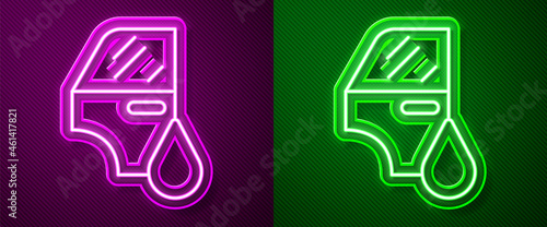 Glowing neon line Car painting icon isolated on purple and green background. Car body repair process. Vector