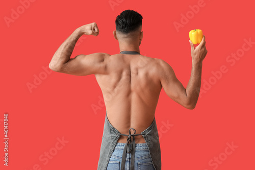 Young man with bell pepper ...