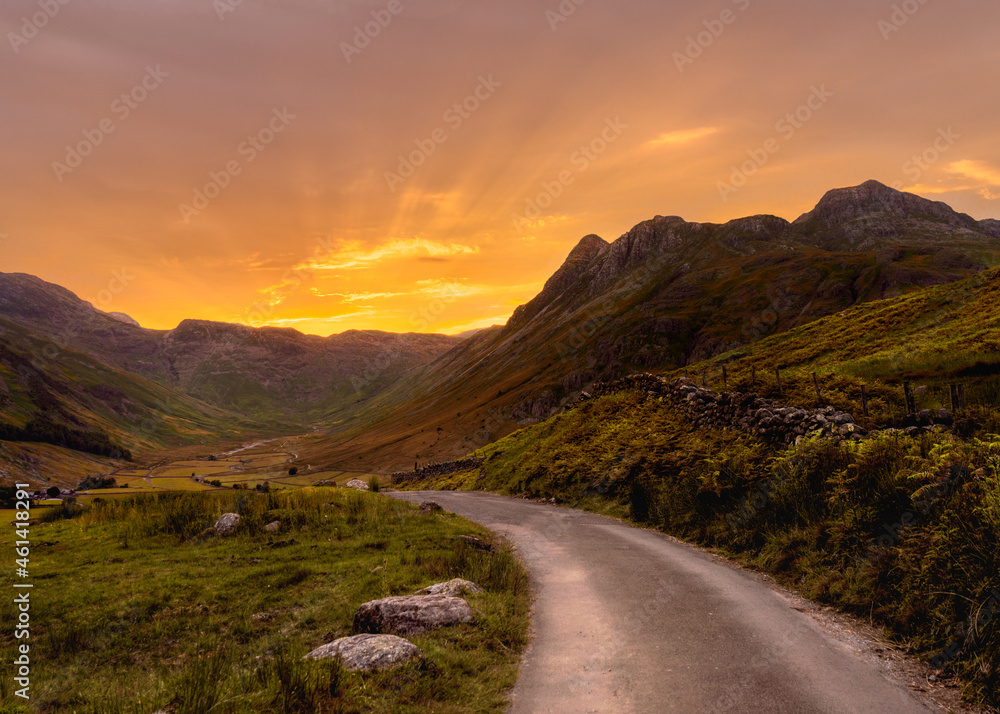 Sunset from Side Pike in the Lake District National Park, England.  The sun is setting over the Langdale Pike.  