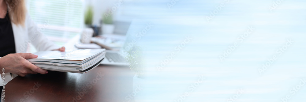 Businesswoman holding magazines; panoramic banner Businesswoman holding magazines; panoramic banner