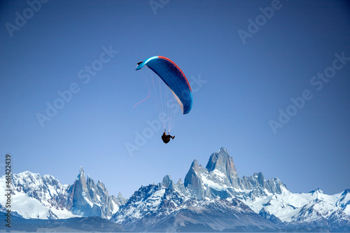 glider paragliding over snowy mountain peaks flying  adrenaline and freedom concept