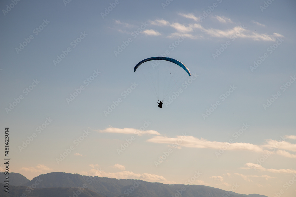 glider paragliding g against blue sky flying  adrenaline and freedom concept