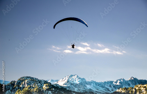 glider paragliding over snowy mountain peaks flying adrenaline and freedom concept