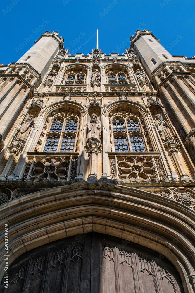 Detail of medieval building with ornate stained glass windows and detailed statues and decorative sculpture in Cambridge England