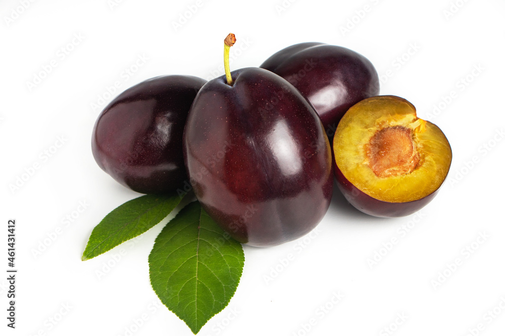 Isolated plums. Whole and a half of blue plum fruit isolated on white background.