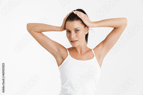 European woman wearing underwear holding her head and looking at camera