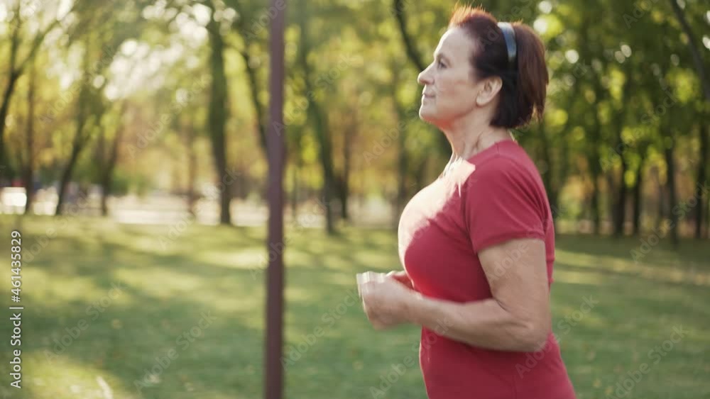 Elderly woman runs at the park Elderly woman runs at the park