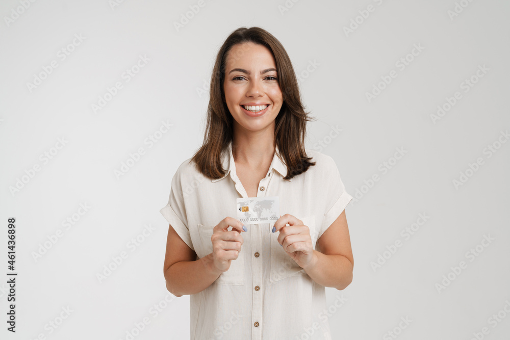 Young european woman smiling while showing credit card Young european woman smiling while showing credit card