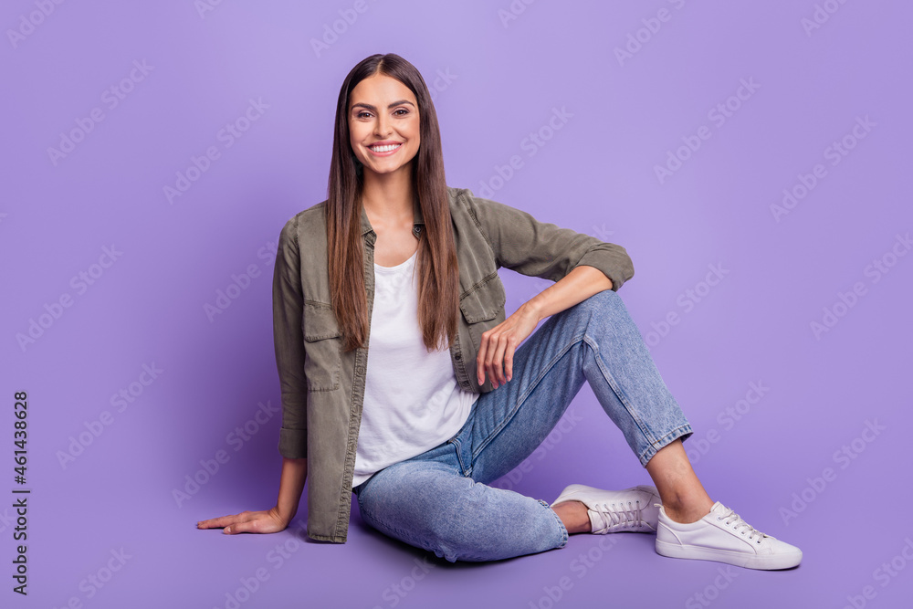 Full length body size photo woman wearing stylish outfit sitting on floor isolated pastel purple color background Full length body size photo woman wearing stylish outfit sitting on floor isolated pastel purple color background