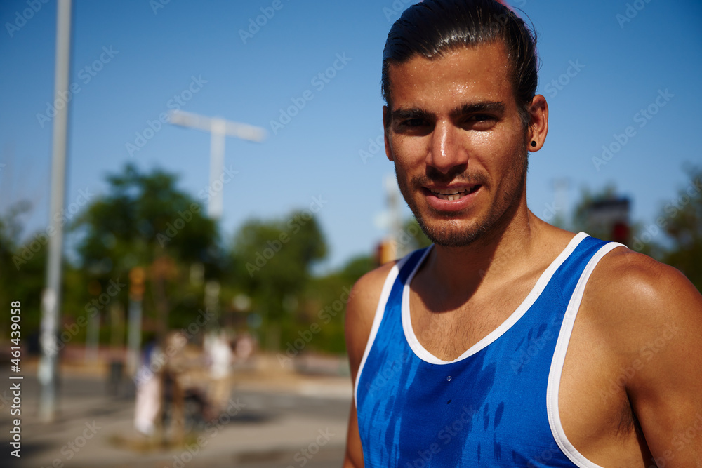 Cheerful young sportsman looking at the camera Cheerful young sportsman looking at the camera