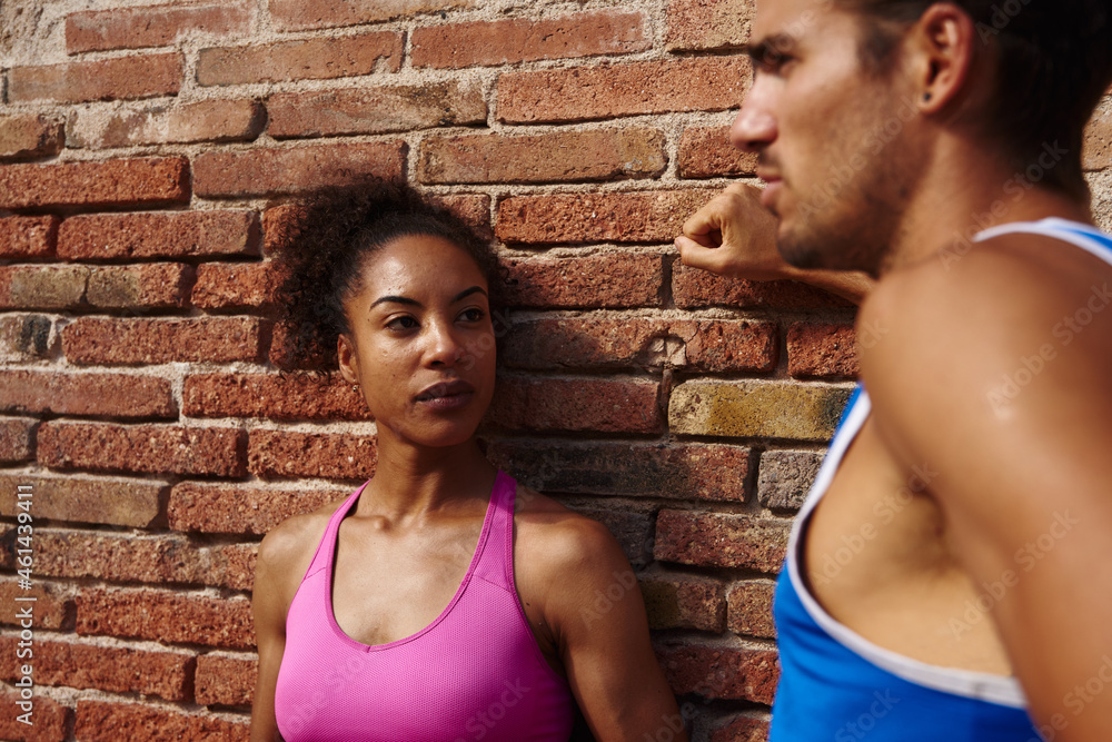 Athletic couple having a chat together outdoors Athletic couple having a chat together outdoors
