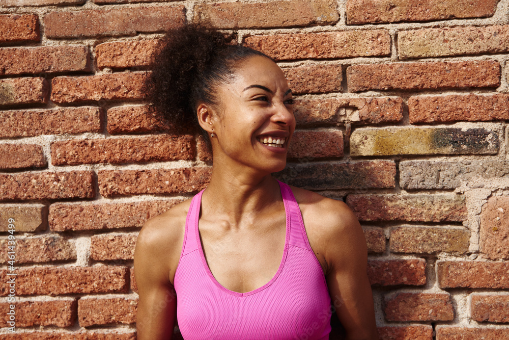 Athletic young woman looking away cheerfully Athletic young woman looking away cheerfully