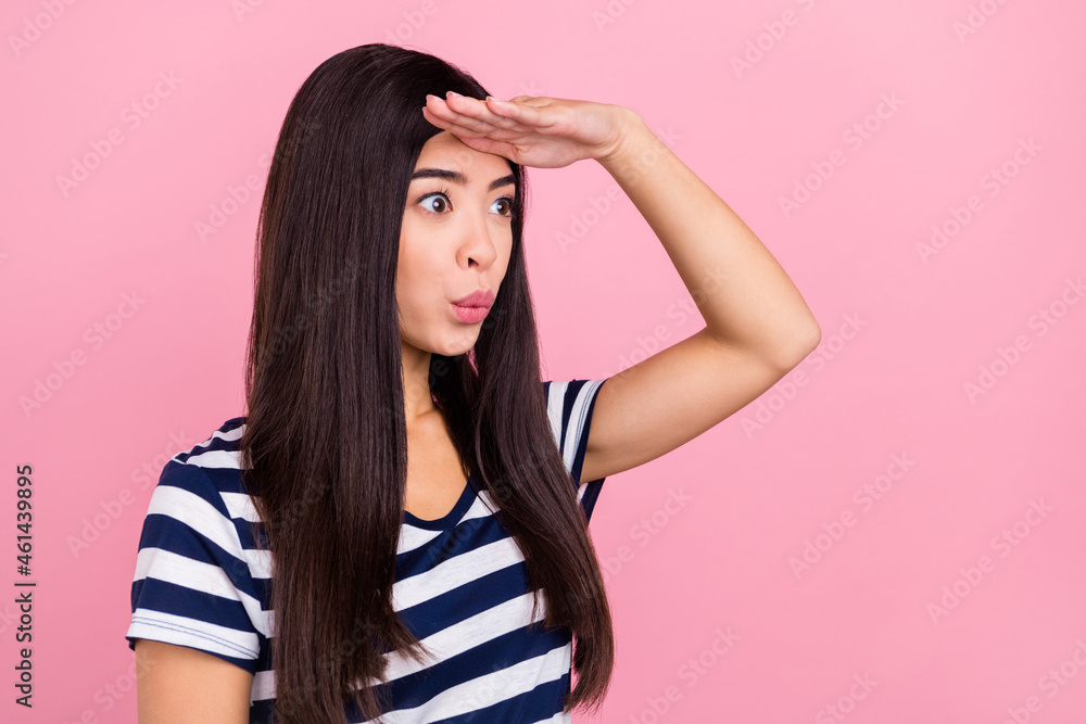 Profile photo of impressed young lady look empty space wear striped t-shirt isolated on pastel pink color background Profile photo of impressed young lady look empty space wear striped t-shirt isolated on pastel pink color background