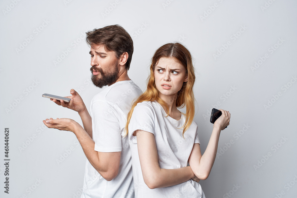 man and woman family with phones in hand communication studio lifestyle man and woman family with phones in hand communication studio lifestyle