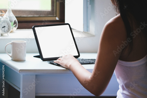 Business Women use a tablet for work  a blank tablet screen can add text or other media.