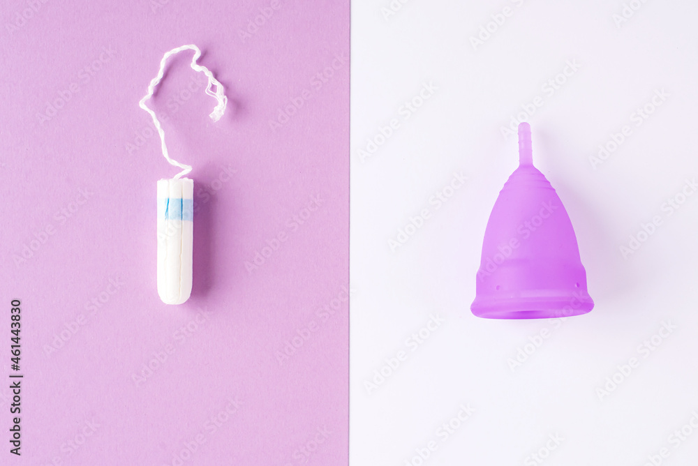 Silicone menstrual cup and tampon. Women's health and alternative hygiene, zero waste alternatives, female intimate hygiene period products, critical days. Top view, White and violet
