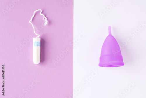 Silicone menstrual cup and tampon. Women's health and alternative hygiene, zero waste alternatives, female intimate hygiene period products, critical days. Top view, White and violet