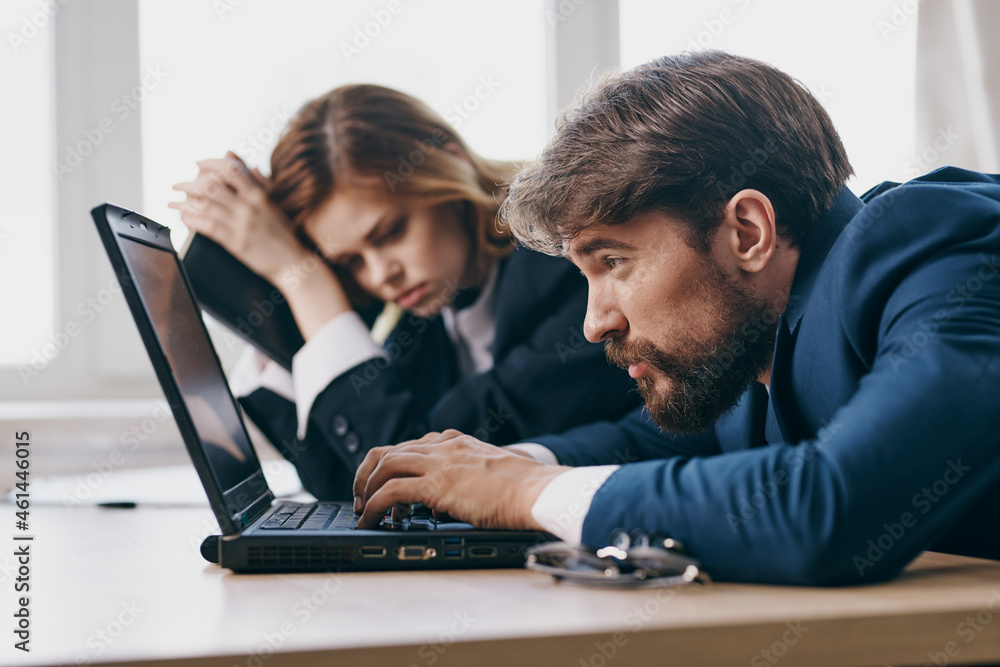 colleagues in the office in front of a laptop career work professionals colleagues in the office in front of a laptop career work professionals
