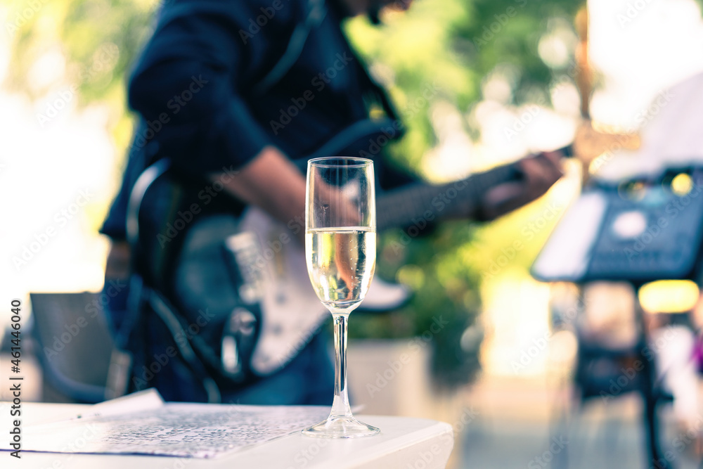 Selective focus on a glass with champagne in a table during a concert