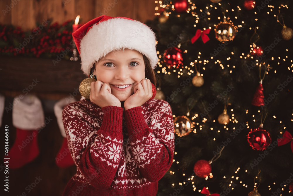 Photo of sweet charming school girl wear print pullover headwear smiling hanging new year balls indoors house home room Photo of sweet charming school girl wear print pullover headwear smiling hanging new year balls indoors house home room