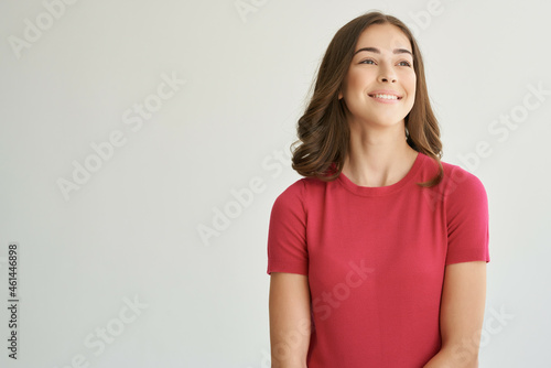 cheerful woman in a red t-shirt hair care isolated background