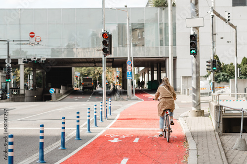 traffic, city transport and people concept - woman cycling along red bike lane with signs of bicycles and two way arrows on street in tallinn, estonia © Syda Productions