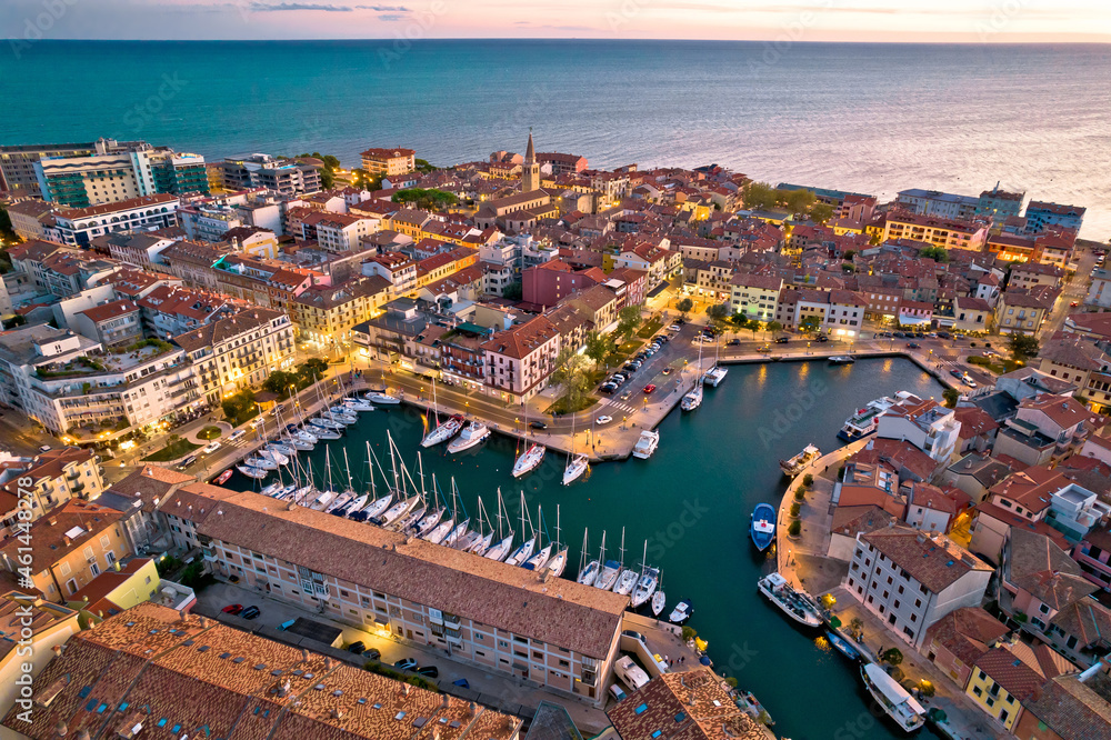 Town of Grado colorful architecture and waterfront aerial evening view