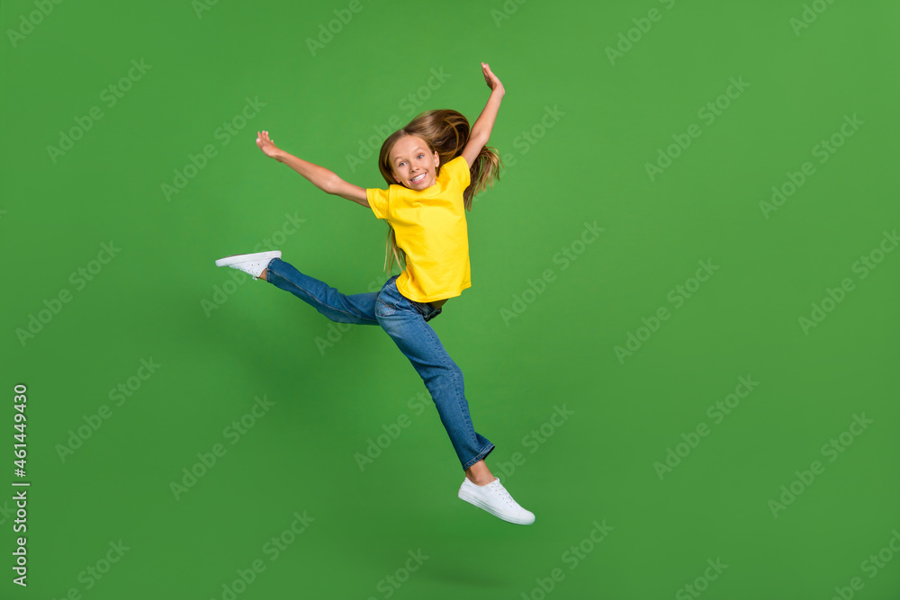 Full length body size view of attractive cheerful girl jumping dancing twine running isolated over vivid green color background Full length body size view of attractive cheerful girl jumping dancing twine running isolated over vivid green color background