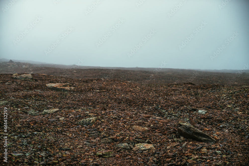 Stone field in dense fog in highlands. Empty stone desert in thick fog. Zero visibility in mountains. Minimalist nature background. Dark atmospheric foggy mountain landscape. Lichens on sharp stones. Stone field in dense fog in highlands. Empty stone desert in thick fog. Zero visibility in mountains. Minimalist nature background. Dark atmospheric foggy mountain landscape. Lichens on sharp stones.