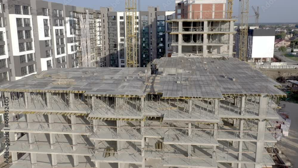 Building crane and monolituc building under construction. Construction site Building crane and monolituc building under construction. Construction site