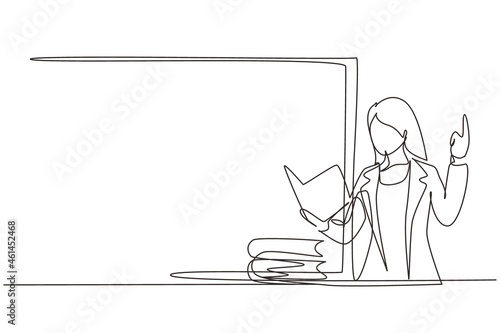 Continuous one line drawing young woman teacher standing in front of class with book on her hands, pile of books on table. Female teacher teach in classroom at school. Single line draw design vector