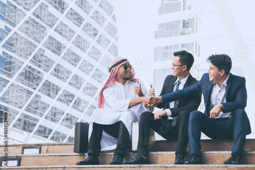 Young businessteam and business partners sitting on stairs for consulting in his business.