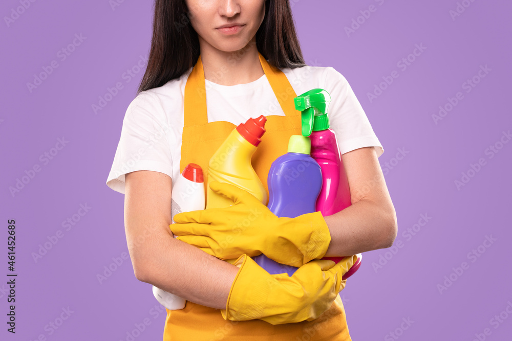 Young housewife with heap of detergents Young housewife with heap of detergents