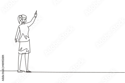 Continuous one line drawing rear view of woman teacher or student writing formulas on classroom chalkboard holding chalk in right hand. University or school education. Single line draw design vector