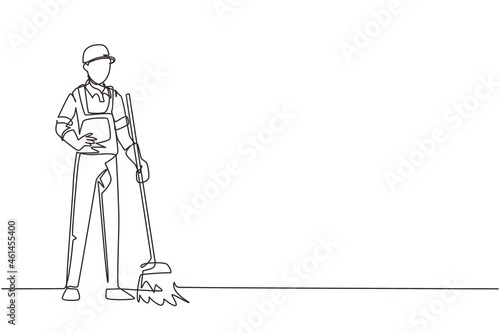 Continuous one line drawing smiling young male janitor standing in uniform, sweeping the floor with broom, professional cleaning, home and office service. Single line draw design vector illustration