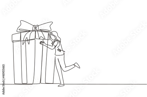 Single one line drawing girl hugging huge birthday gift. Young satisfied woman standing near wrapped birthday gift box with bow. Present, birthday. Continuous line draw design vector illustration