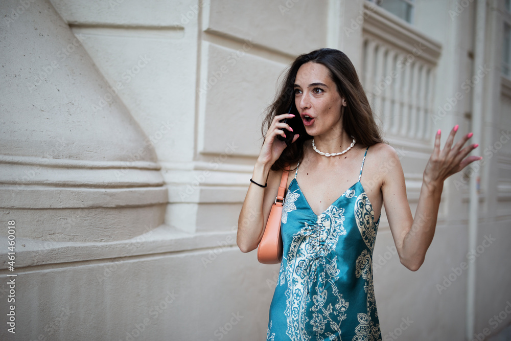 Beautiful young elegance woman using the phone. Beautiful fashion woman talking to the phone.