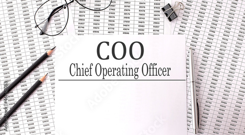 Papers with text, COO - Chief Operating Officer on the table, business concept.