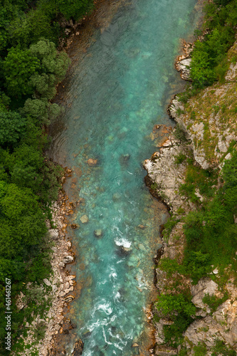 Mountain beautiful river with clear blue water, in the middle of the forest and stones. Natural untouched nature. Top view.