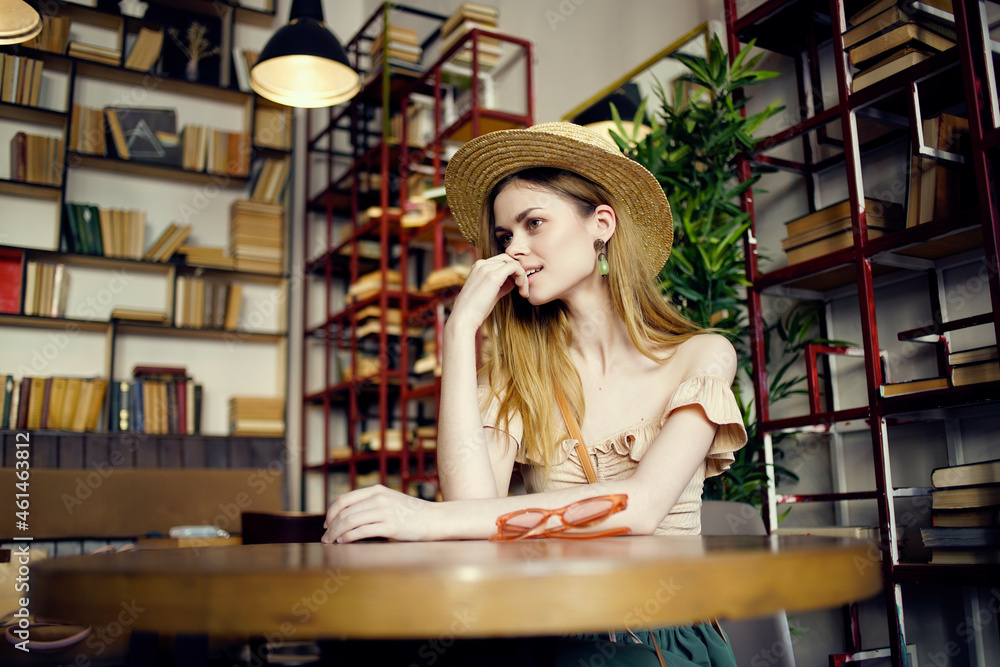 pretty woman reading a book in a cafe Lifestyle