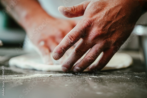 raw dough pastry is being prepared by chef closeup hands man 